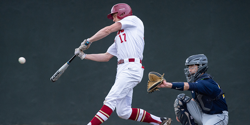 Luke Werkmeister-Martin is about to hit the ball as he swings.