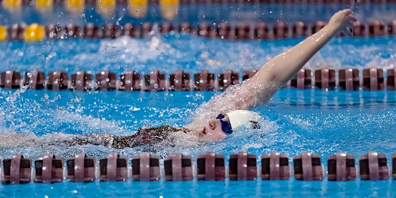 Tatum Good swims the backstroke for Willamette.