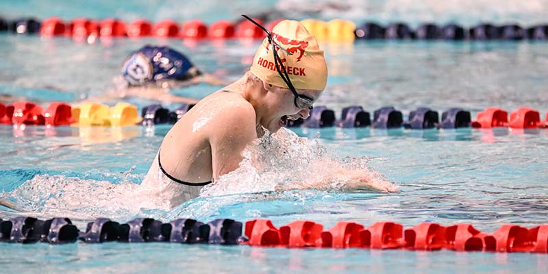 Anna Hornbeck swims the breaststroke at the 2022 NWC Championships.