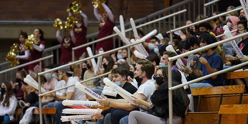 Fans cheer for the Bearcats and use long plastic balloons as noisemakers during a game at Play for ABTA (American Brain Tumor Association) night.