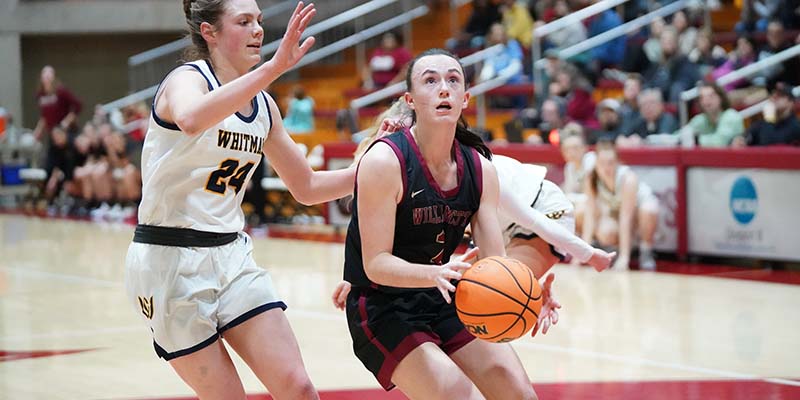 Sami Riggs grabs the ball as she prepares to shoot.